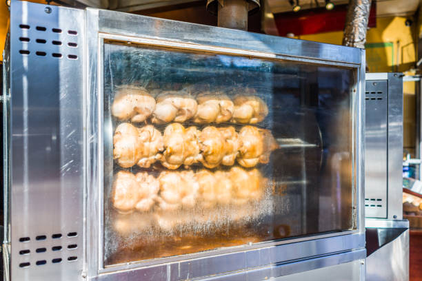 istock Rotisserie chicken machine with many plump birds roasting 699417020