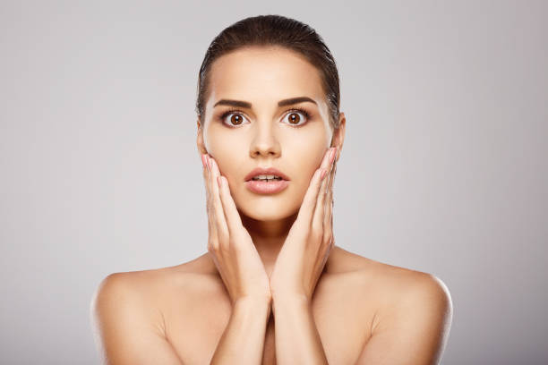 istock Shocked girl with nude make up at studio 699432084