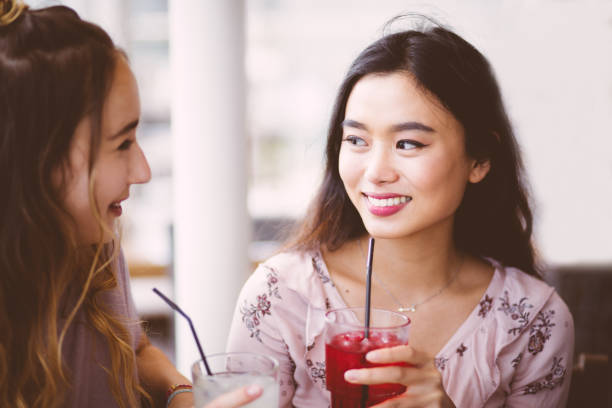 istock Beautiful young women having a drink at a restaurant 699438518