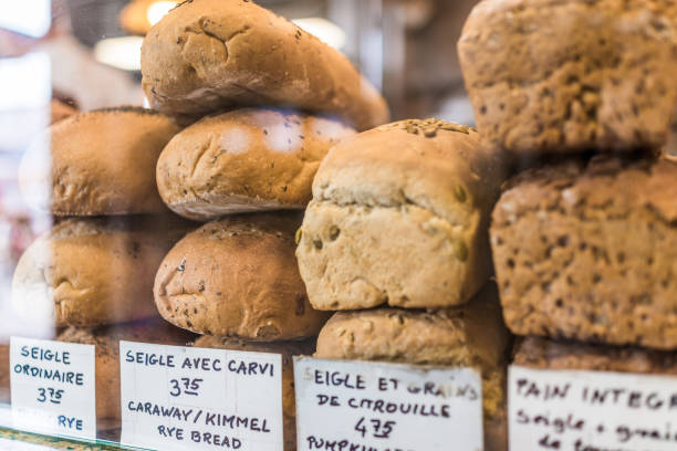 Rye bread display with signs in French at bakery behind window