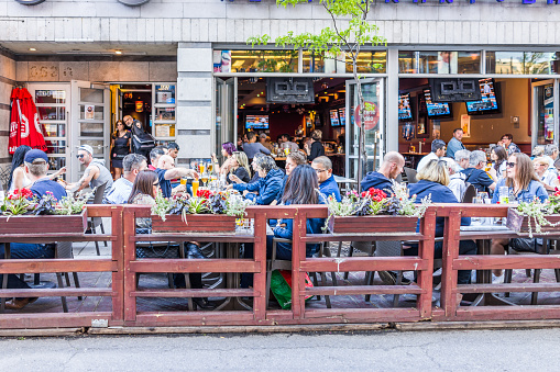 Montreal: People sitting in restaurant at table in outside seating area in Gay Village neighborhood in city in Quebec region