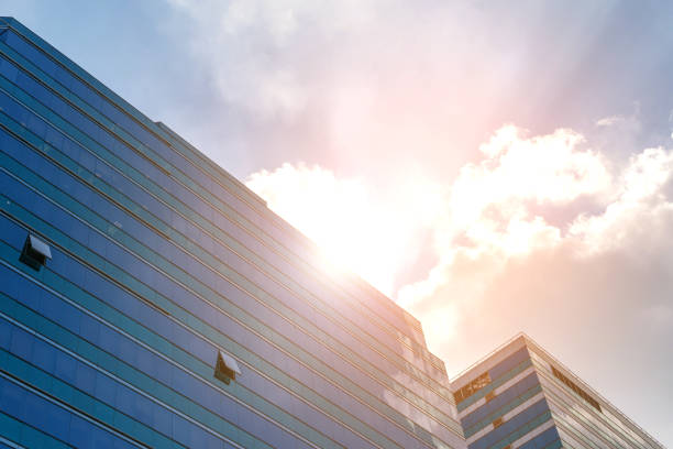 istock Big glass office building with blue sky and white cloud 699518136