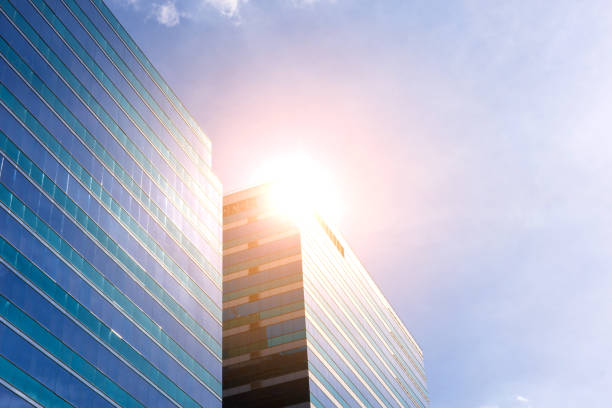 istock Big glass office building with blue sky and white cloud 699518150