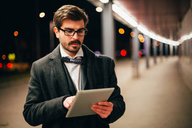 istock Handsome bearded formalwear businessman using digital tablet 699518378