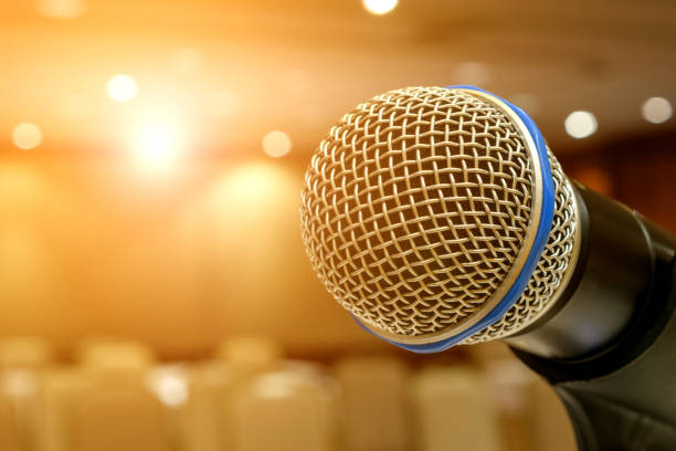 istock Microphone in seminar event defocus on meeting room background 699519014