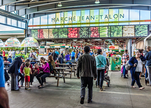 Montreal: Jean Talon market sign and entrance with people in Little Italy neighborhood in city in Quebec region