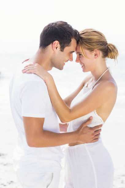 istock Young couple standing face to face and romancing 699558656