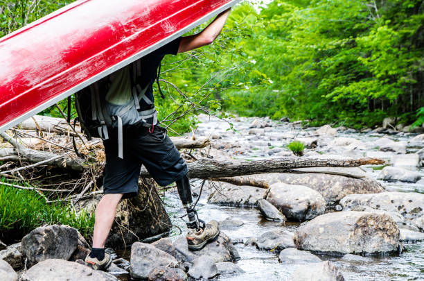 men carrying kayaks
