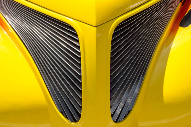 istock Symmetric front grill on a yellow car 699586904