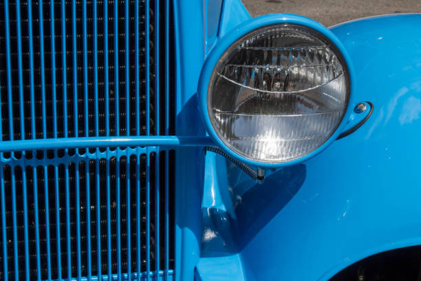 istock Antique light blue car, close up of a single headlight 699588058