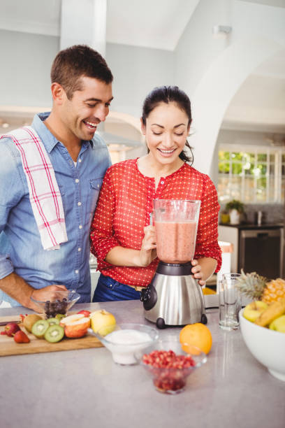 istock Laughing couple with fruit juice 699645344