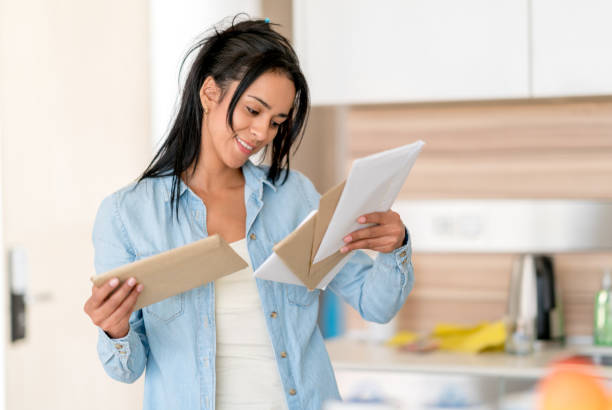 istock Woman at home checking her mail 699702868