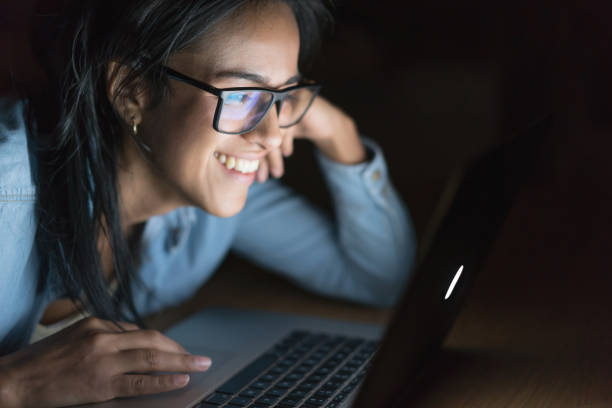 istock Happy woman browsing online at home 699704090