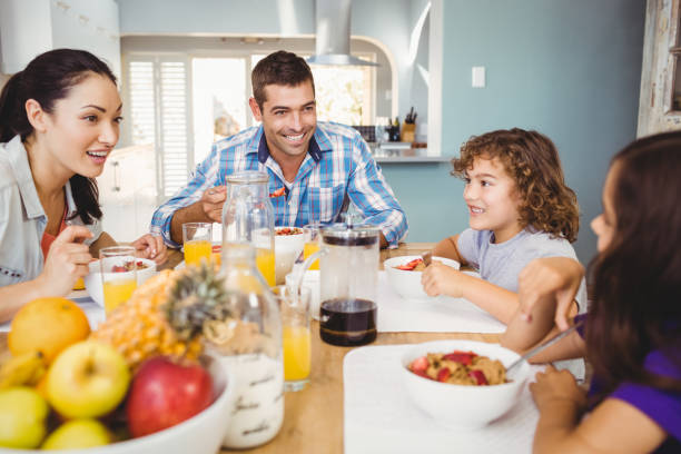 istock Cheerful family eating breakfast at table 699713008