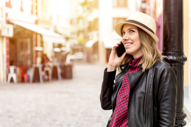 istock Young woman using phone outdoors 699726040