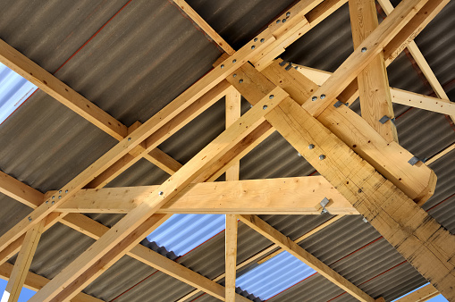 detail of the timber assembly under  roof of a hangar