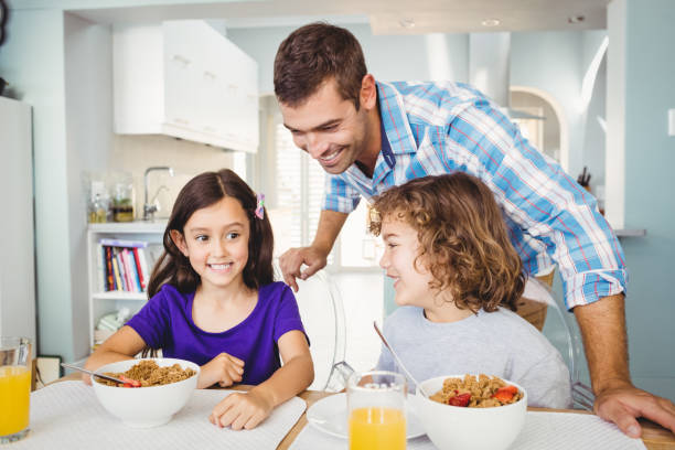 istock Happy man with children having breakfast 699737308