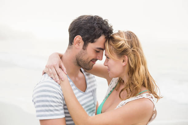 istock Young couple embracing each other on the beach 699748204