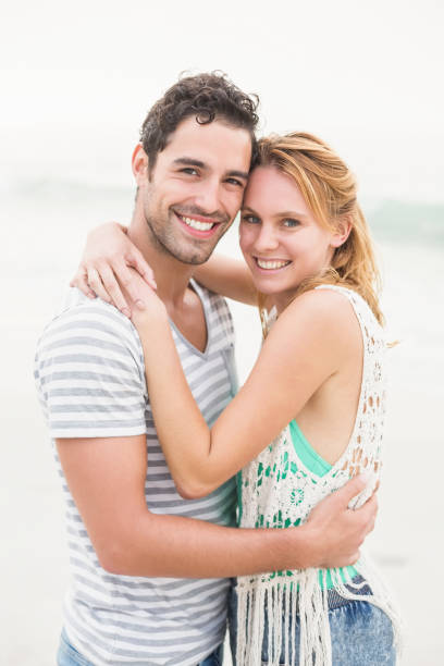 istock Young couple embracing each other on the beach 699748224