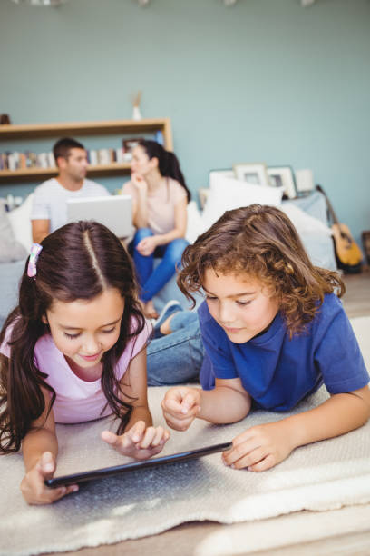 istock Close-up of siblings with digital tablet 699748670