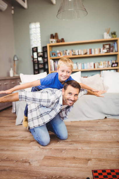istock Cheerful father and son playing on hardwood floor 699748862
