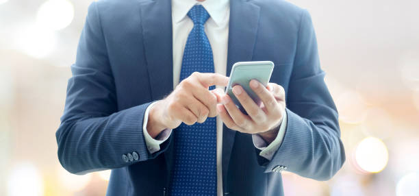 istock Business man hands using smart phone over blur office with copy space background, businessman on phone 699767130