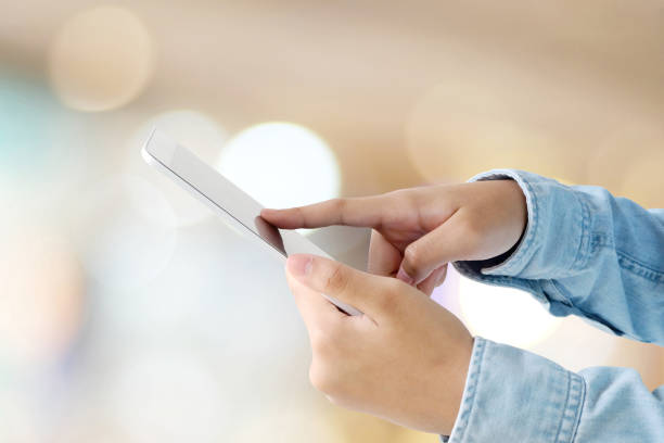 istock Hand using tablet over blur store with bokeh light background, banner, business and technology concept, digital marketing, seo, e-commerce 699767354