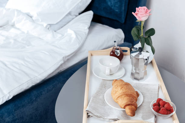 istock Tray with breakfast on table near bed in bedroom 699768816