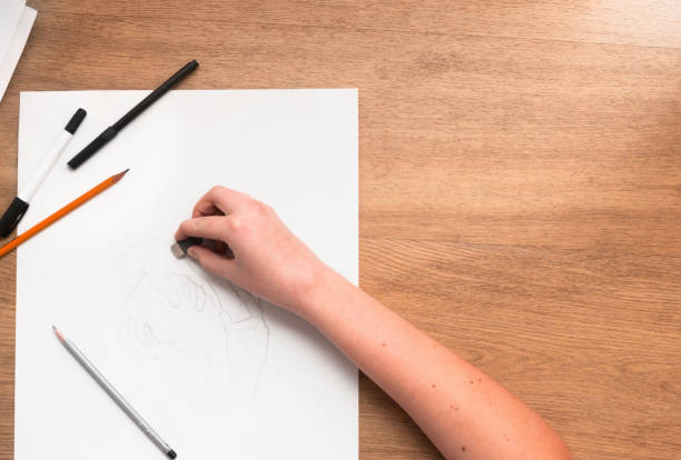 istock Person erasing lines on sketch 699779212
