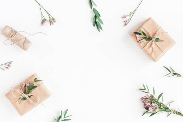 istock Gifts, pink flowers and eucalyptus branches. Flat lay, top view 699794368