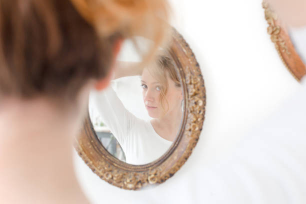 istock Girl preens in front of mirror 699794452
