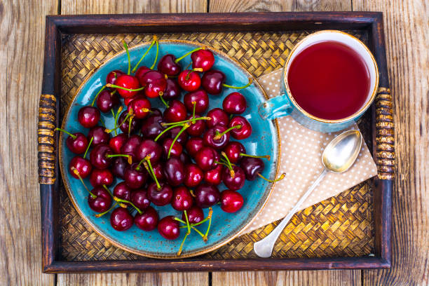 istock Cherry compote and ripe berries on tray 699798816