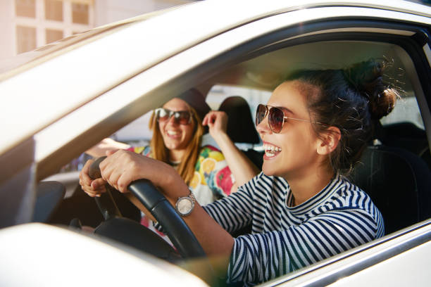 istock Laughing young girlfriends traveling in a car 699799582