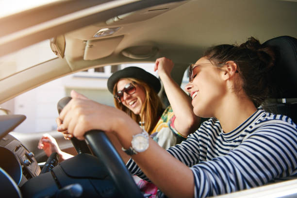 istock Two young woman singing along in the car 699802500
