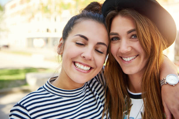 istock Two cute smiling young girl friends 699804092