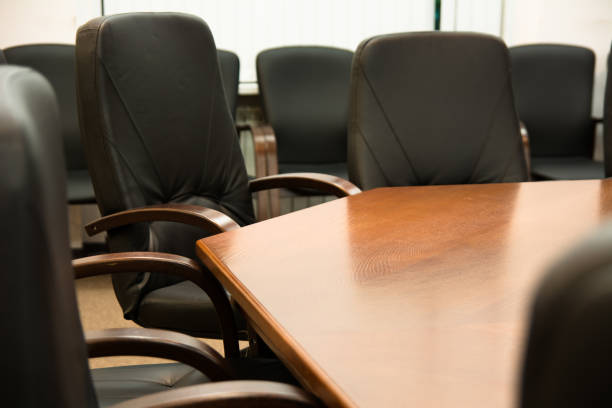 istock Leather armchairs around of a wooden table 699807368