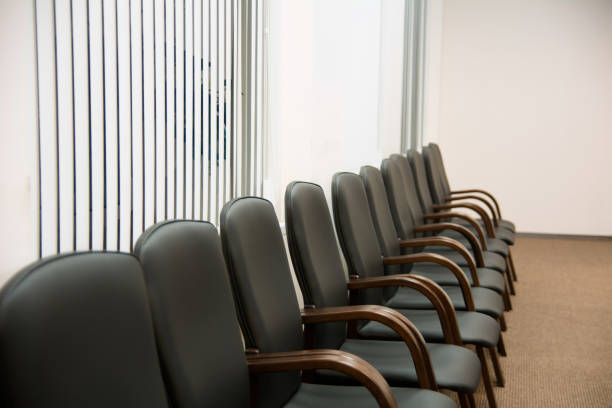 istock Leather black chairs are standing near the wall 699807386