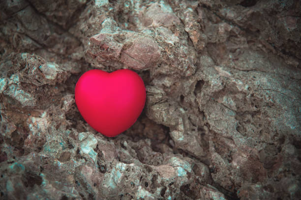 istock Red heart on the rock. Vintage tone 699808308