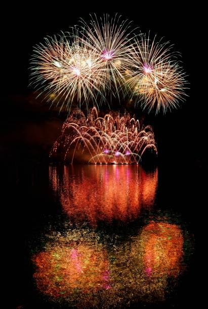 istock Firework. Beautiful colorful fireworks on the water surface with a clean black background. Fun festival and contest of Firefighters  Brno Dam - Czech Republic. 699814072