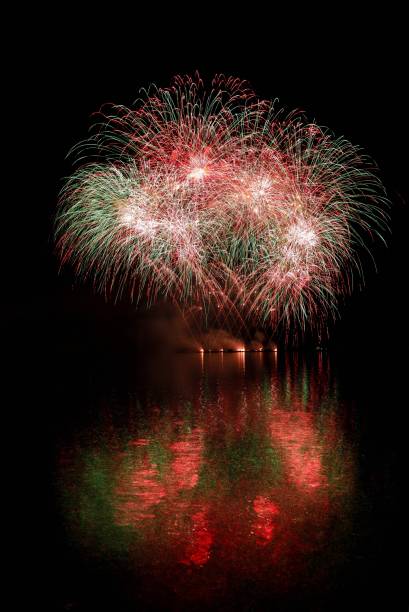 istock Firework. Beautiful colorful fireworks on the water surface with a clean black background. Fun festival and contest of Firefighters  Brno Dam - Czech Republic. 699816362