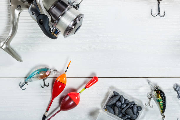 istock Fishing accessories on a wooden background. 699817288