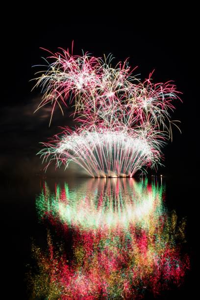 istock Firework. Beautiful colorful fireworks on the water surface with a clean black background. Fun festival and contest of Firefighters  Brno Dam - Czech Republic. 699817306
