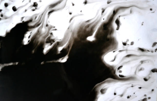 istock Black Ink Conveyed Over White Close-up Paper. 699818234