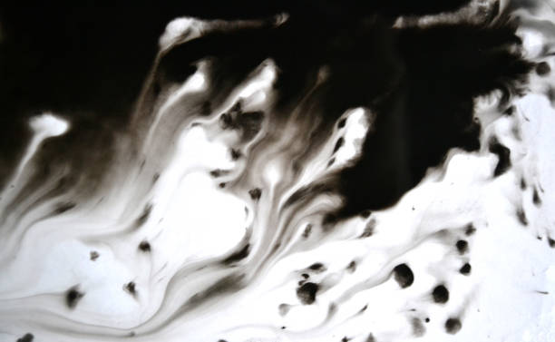 istock Black Ink Conveyed Over White Close-up Paper. 699818372