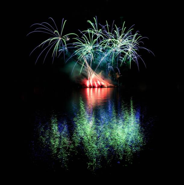 istock Firework. Beautiful colorful fireworks on the water surface with a clean black background. Fun festival and contest of Firefighters  Brno Dam - Czech Republic. 699821008