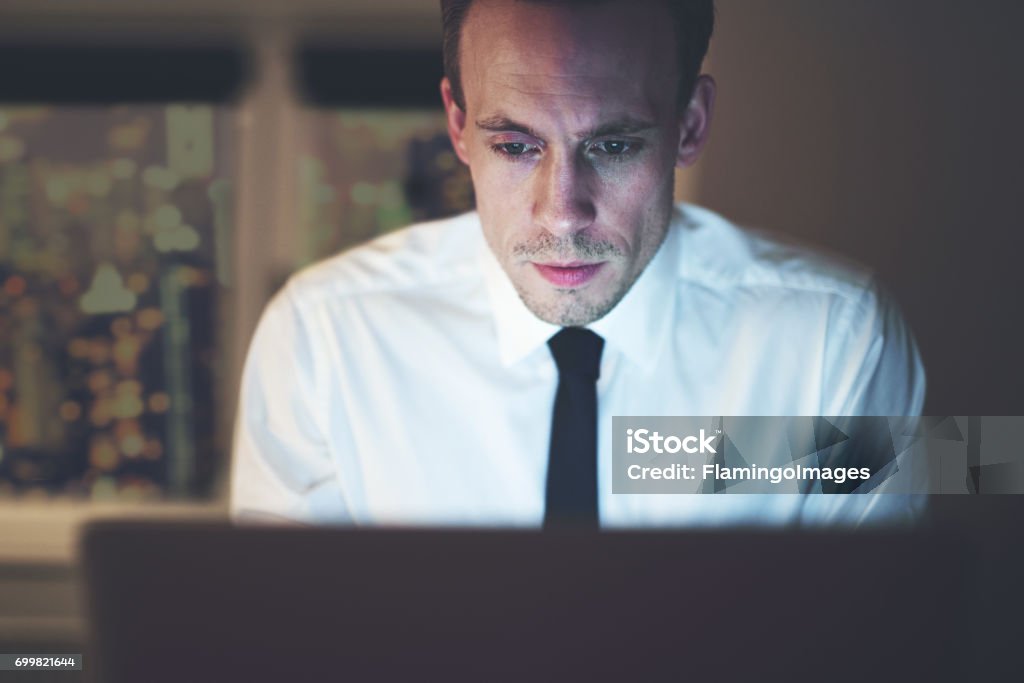 Close up of businessman working overtime on computer Close up of businessman working overtime on computer, late night work Accountancy Stock Photo