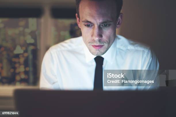 Close Up Of Businessman Working Overtime On Computer Stock Photo - Download Image Now