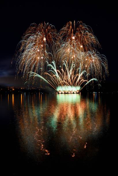 istock Firework. Beautiful colorful fireworks on the water surface with a clean black background. Fun festival and contest of Firefighters  Brno Dam - Czech Republic. 699821672