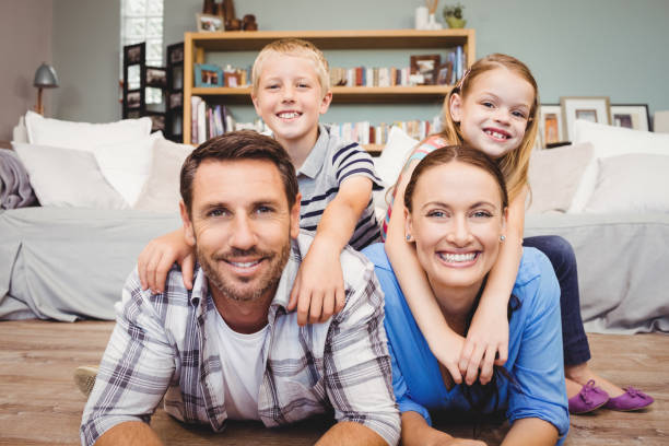 istock Parents lying on floor while children sitting on their back 699822140