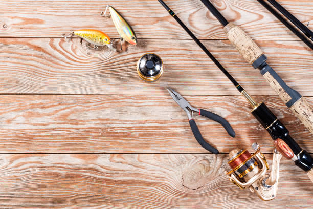 istock Fishing accessories on a wooden background. 699823666